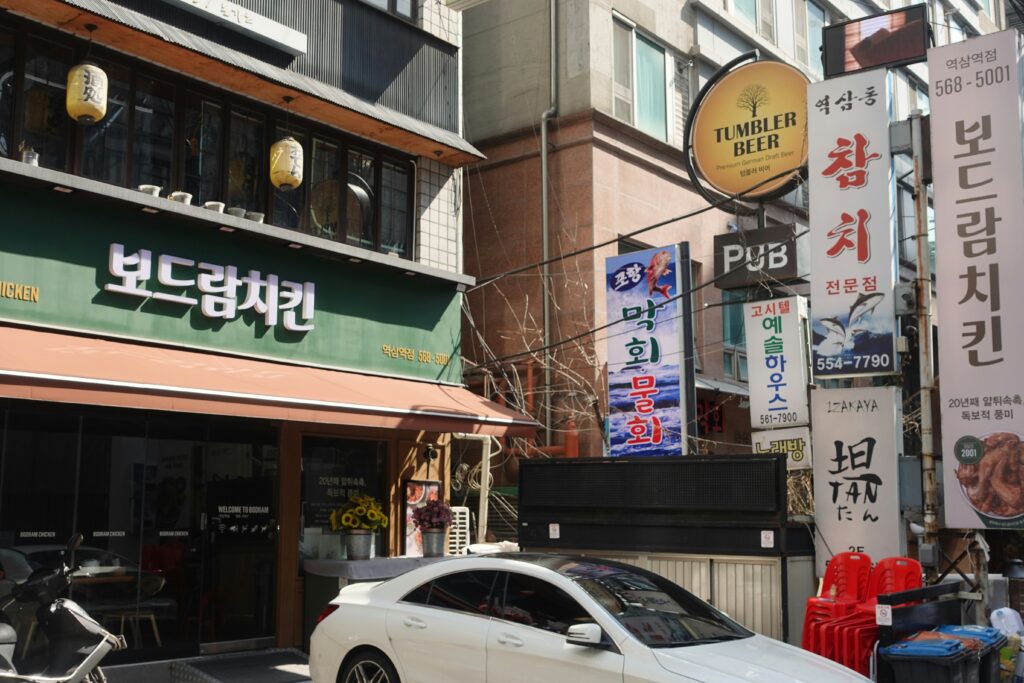 family writing Hangul characters in Korean restaurant, festive mood, realistic high quality photo
